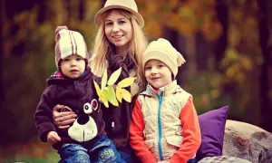 Uśmiechnięta mama z dwójką dzieci w jesiennym lesie. Marzy o emeryturze za 4 dzieci, ale na razie cieszy się chwilą.